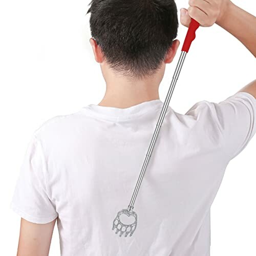 Person using a metal back scratcher on their back.