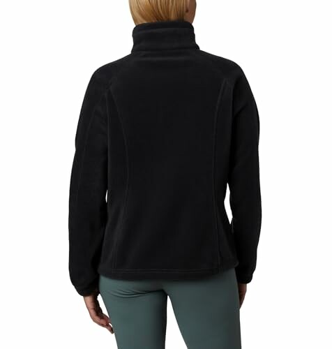 Back view of person wearing black fleece jacket