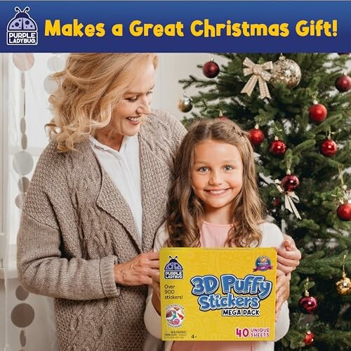 Woman and girl holding 3D Puffy Stickers box in front of Christmas tree.