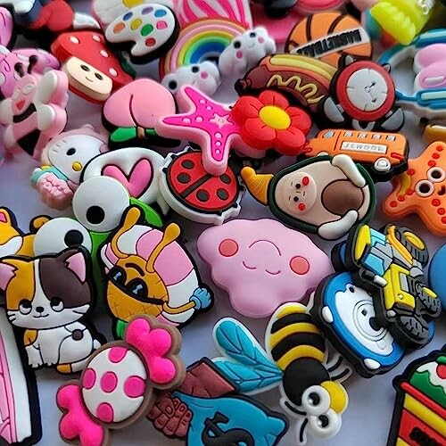 A collection of colorful cartoon charms including animals, flowers, and various shapes.