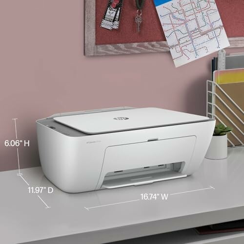 Compact white printer on a desk with dimensions displayed.