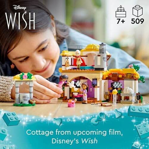 Child playing with Disney Wish Lego cottage set