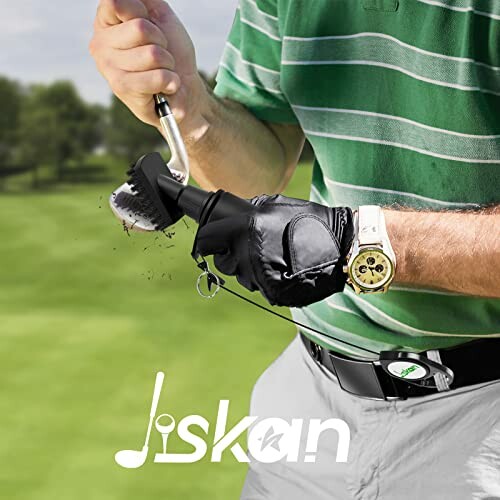 Golfer cleaning a golf club with a brush on a course.