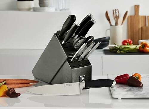 Kitchen knife set on a counter with vegetables